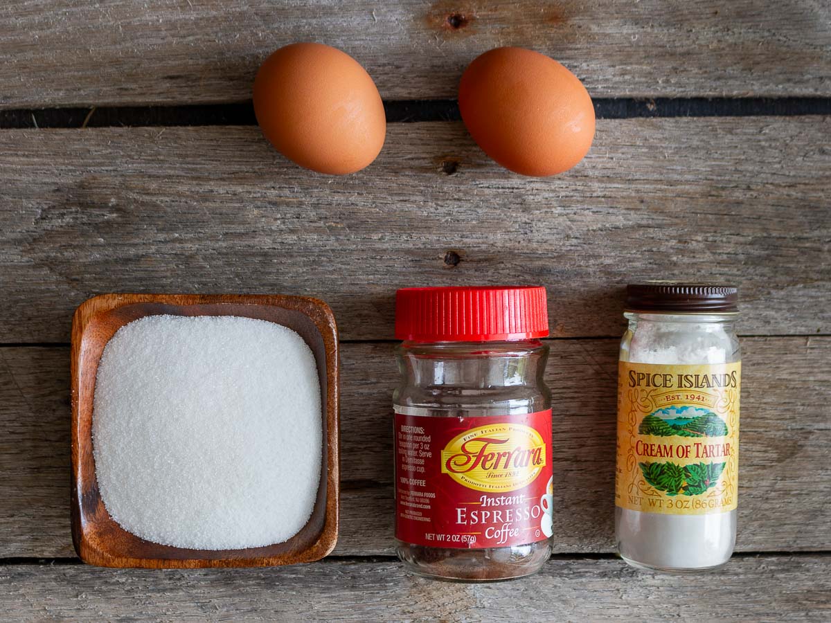 Ingredients to make the marshmallow meringue laid out on a rustic wooden board.  