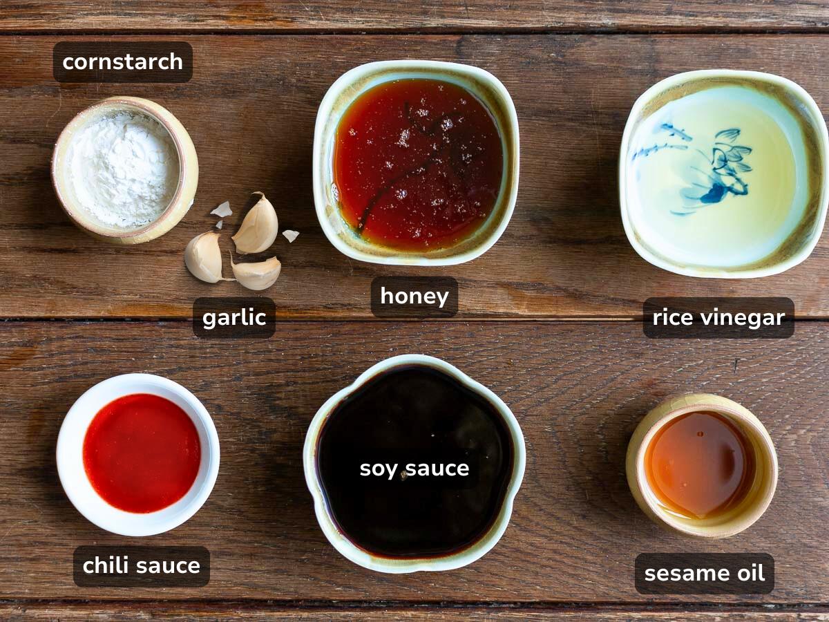 Ingredients to make a homemade copycat Buffalo Wild Wings Asian Zing Sauce on a wooden table without refined sugar.