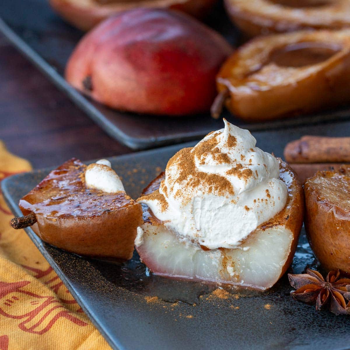 A baked pear half cut in half showing how juicy they are. 