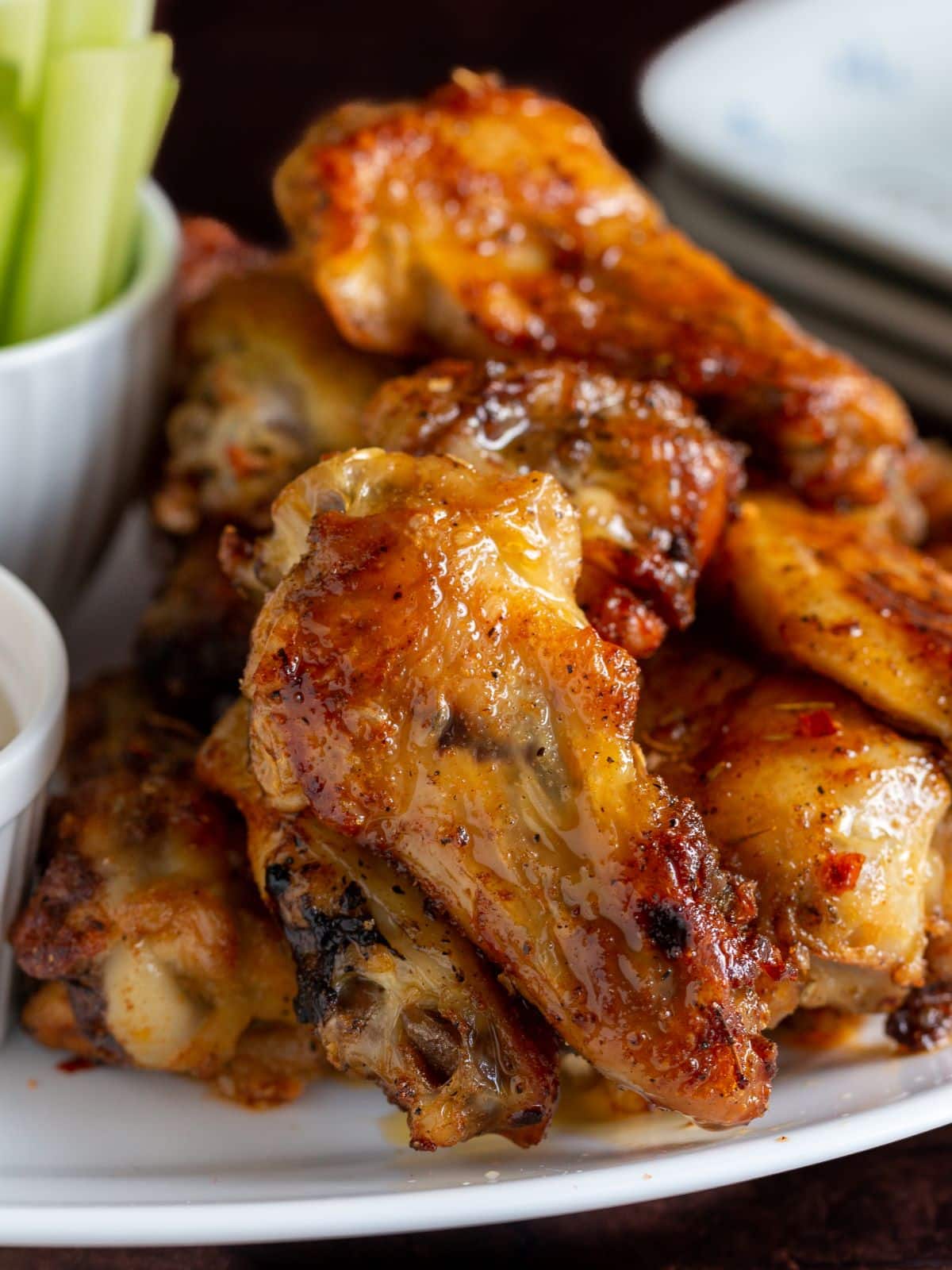 Baked chicken wings on a white plate. 