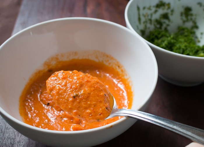 Roasted Red Pepper pesto in a white bowl. 