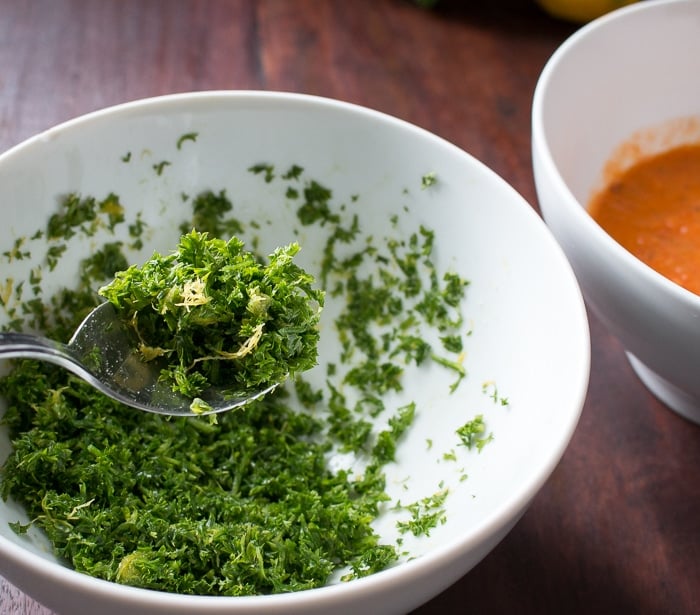 lemony gremolata in a white bowl getting mixed. 