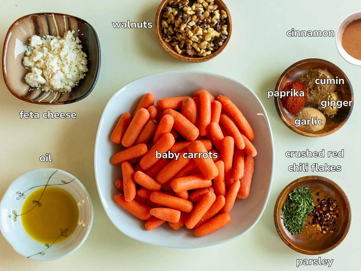 Ingredients to make carrots in the air fryer laid out on a bright board. 