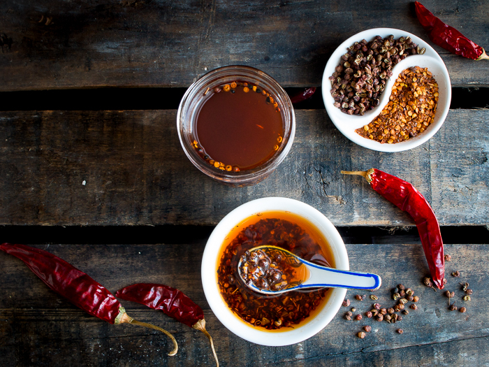 Chili oil with ground chili peppers and Sichuan peppercorns in a yin and yang bowl