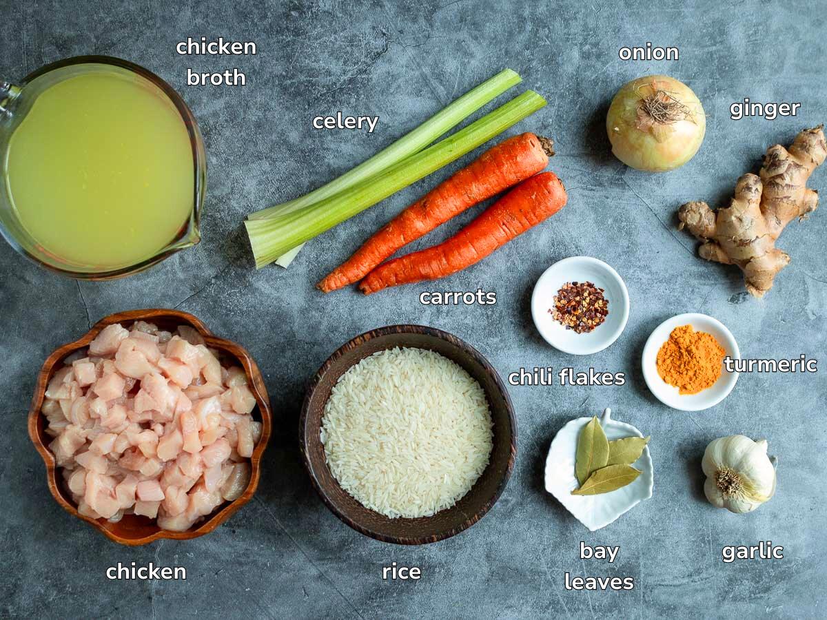 Ingredients to make chicken and rice soup laid out on a blue-grey mat.